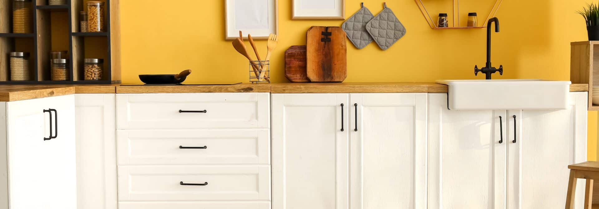 bright yellow painted kitchen with white cabinets