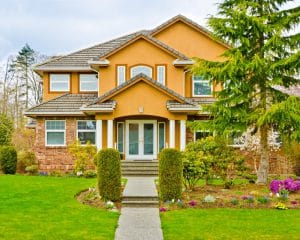 freshly painted gold and white home for a fresh front yard curb appeal 