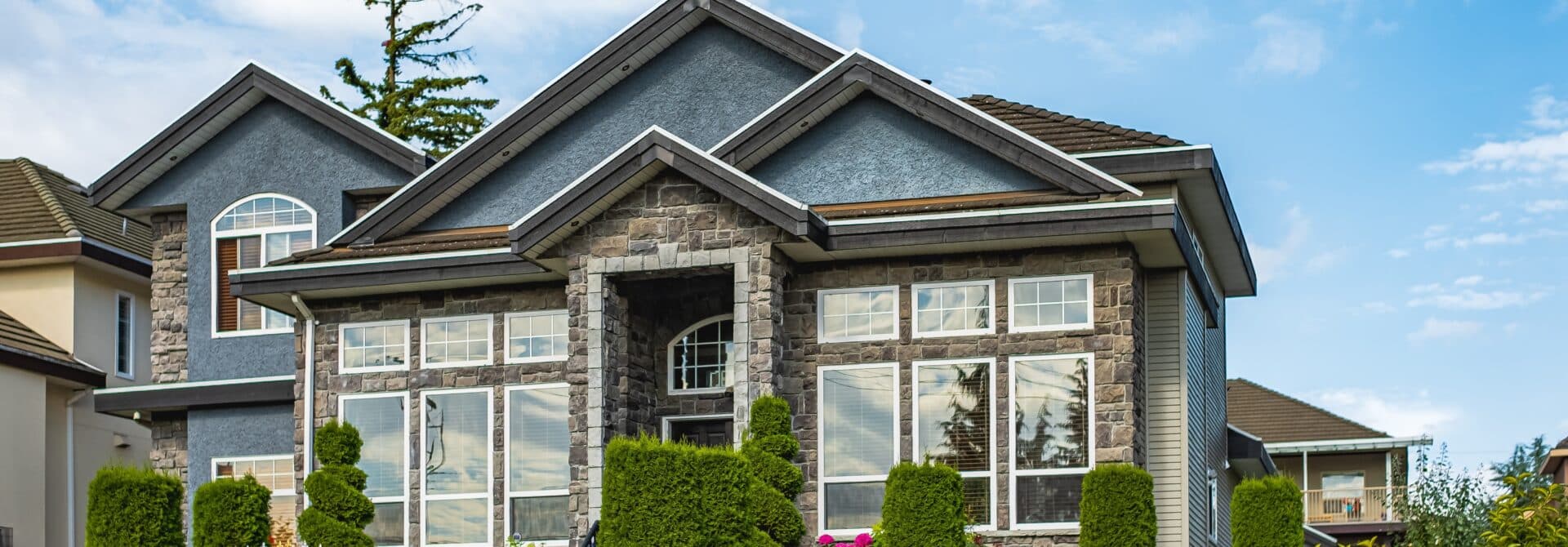 big home with windows, fresh paint job, blue skies and great front yard curb appeal