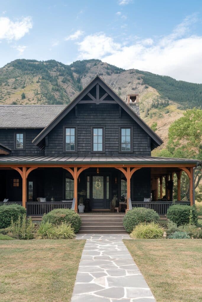 A beautiful modern farmhouse painted black with wood trim.