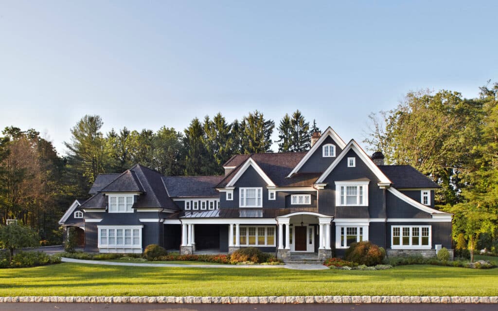 A traditional home with black paint and white wood trim.